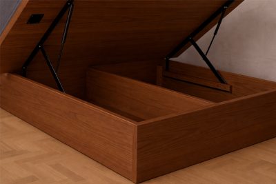 Storage bed frame with open hydraulic compartment showing internal storage space